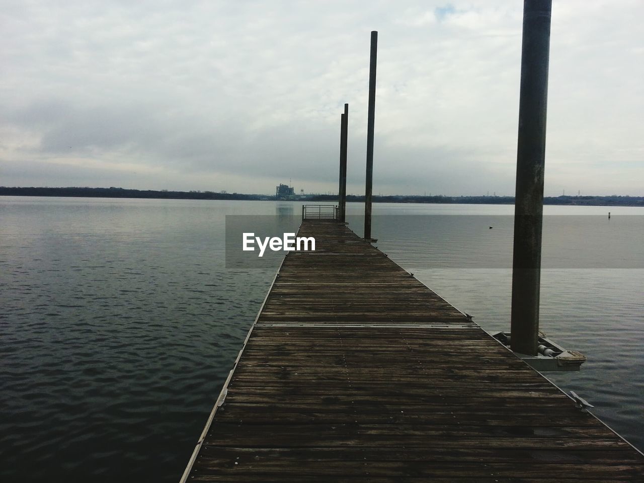 High angle view of pier over river against cloudy sky