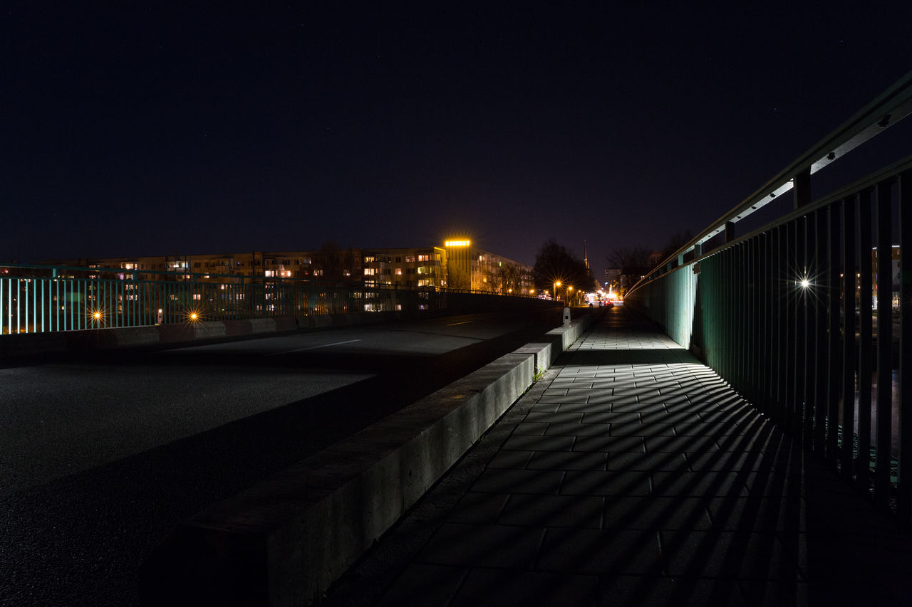 Illuminated buildings against sky at night