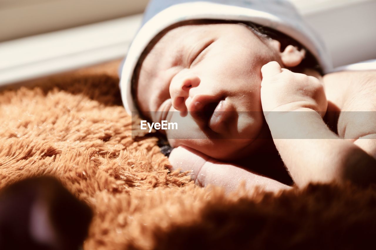 Close-up of baby boy sleeping at home