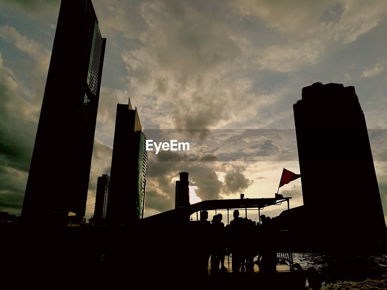 Low angle view of silhouette building against cloudy sky