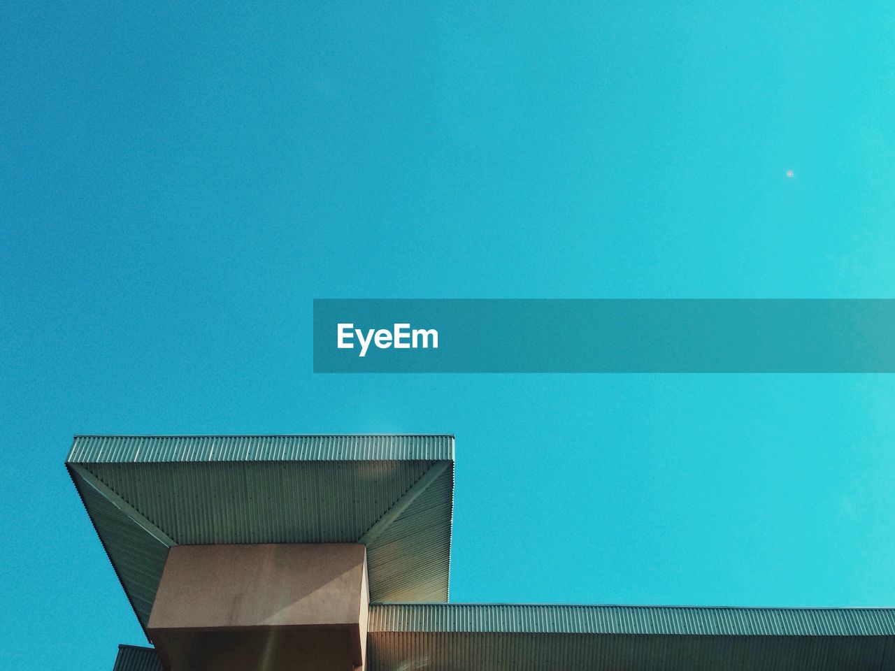 Low angle view of building against clear blue sky