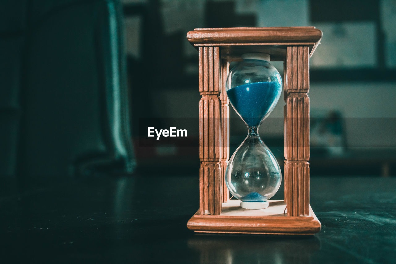 Close-up of hourglass on table