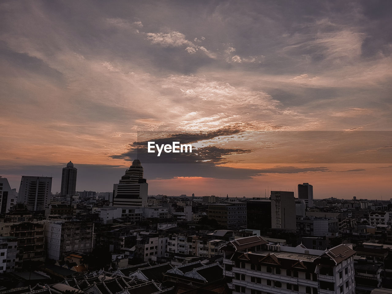 High view of buildings in city during sunset