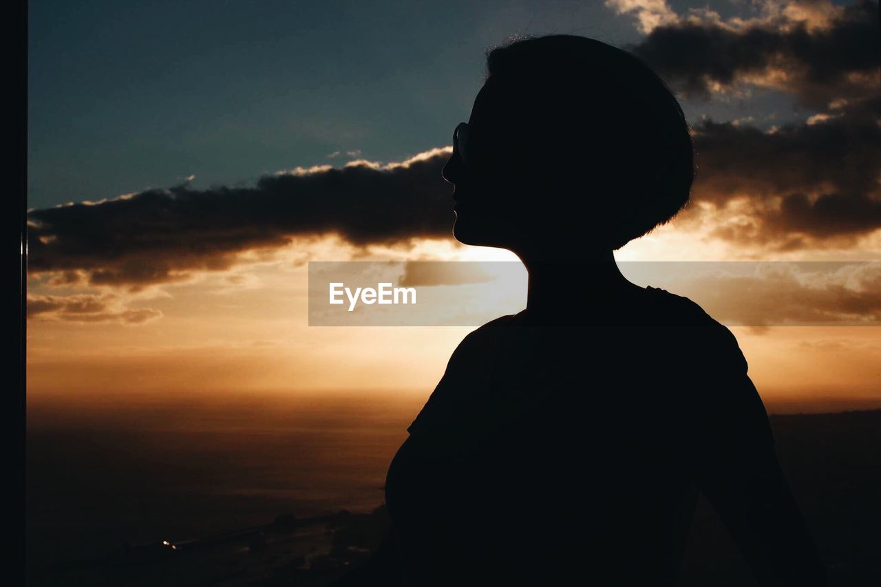 SILHOUETTE OF MAN AGAINST SKY DURING SUNSET