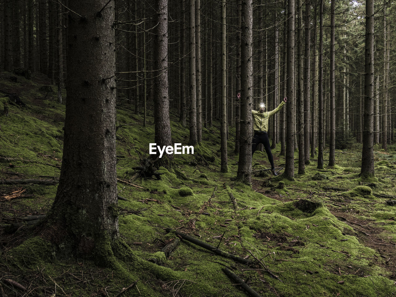 Man running through forest