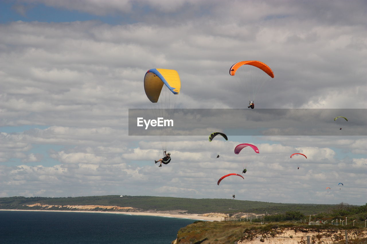 Low angle view of kite flying over sea against sky