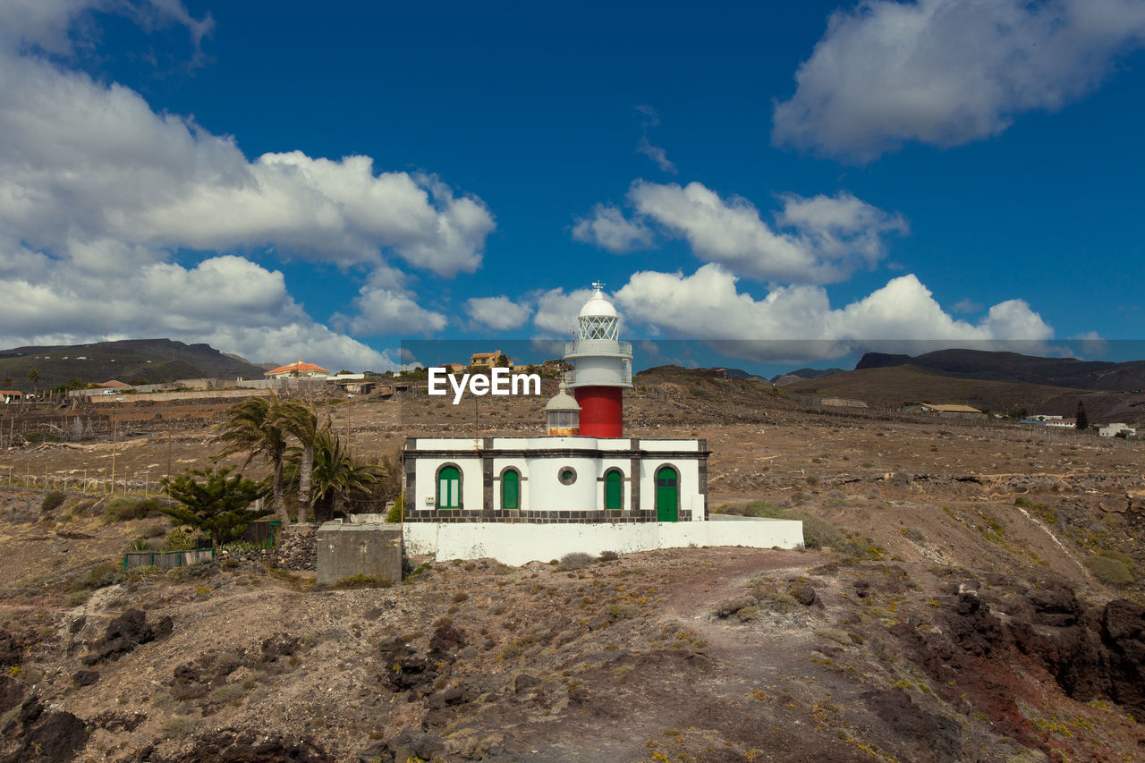 Building on mountain against sky