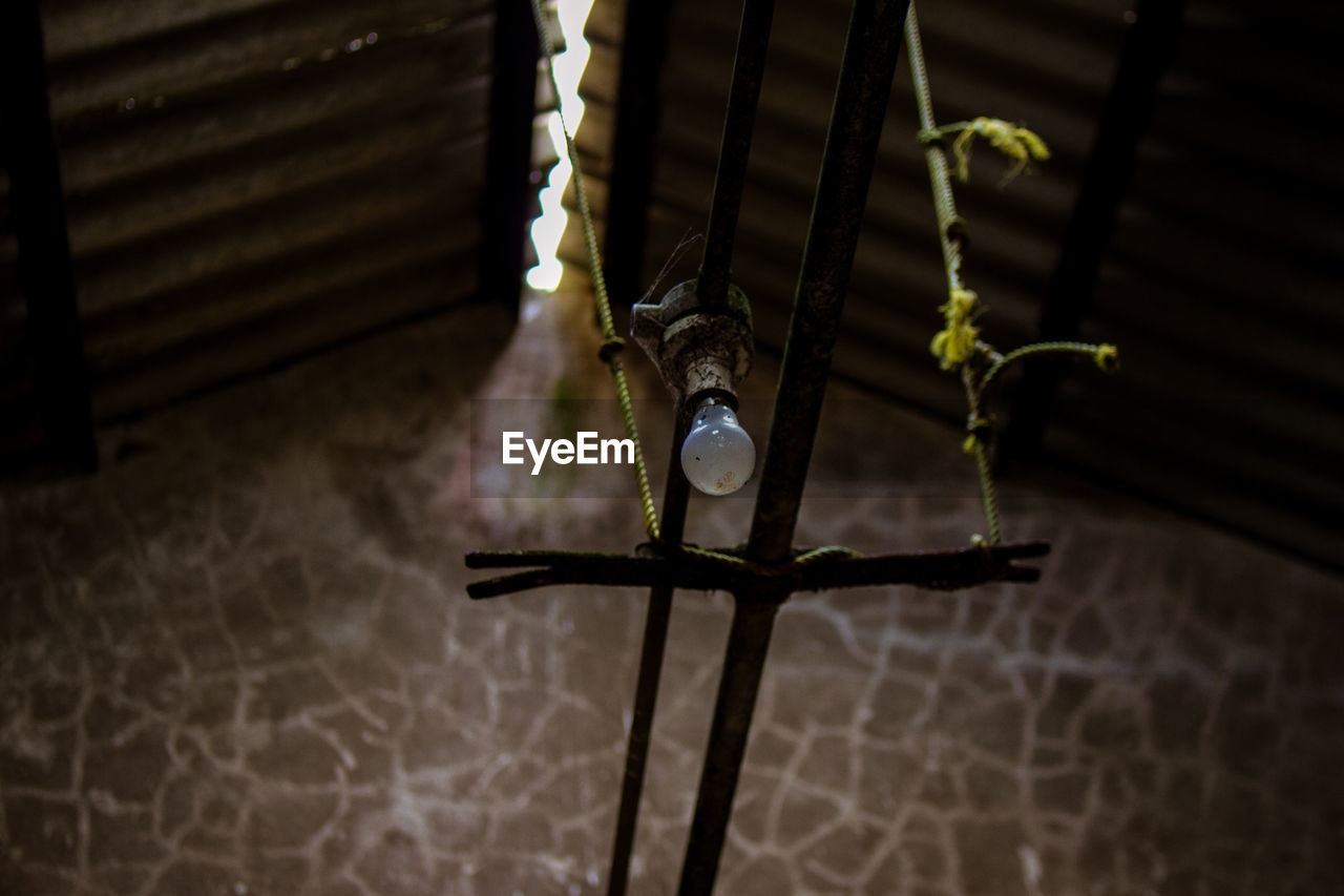 HIGH ANGLE VIEW OF CROSS HANGING ON WALL