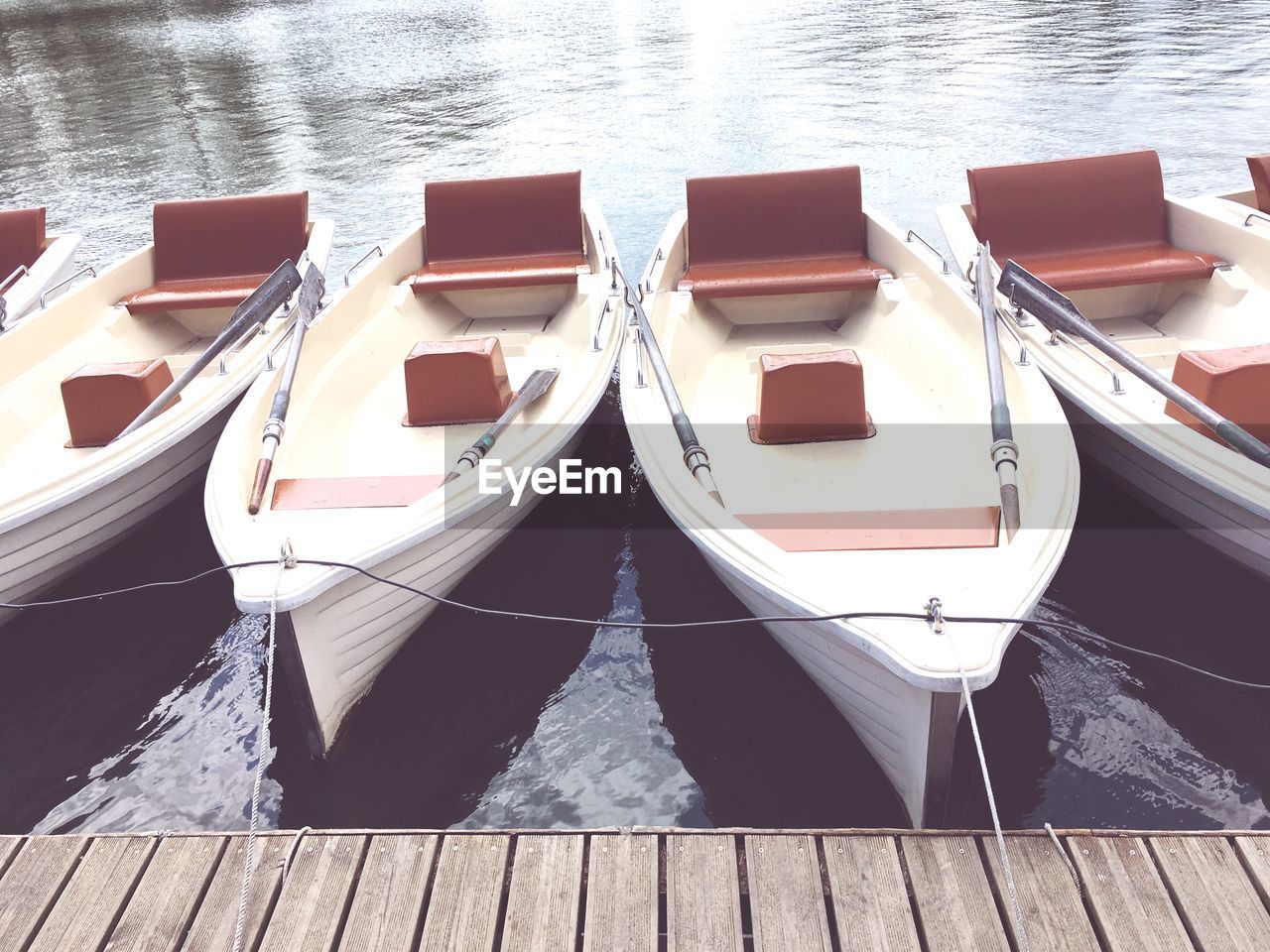 HIGH ANGLE VIEW OF PIER AND BOATS MOORED AT LAKE