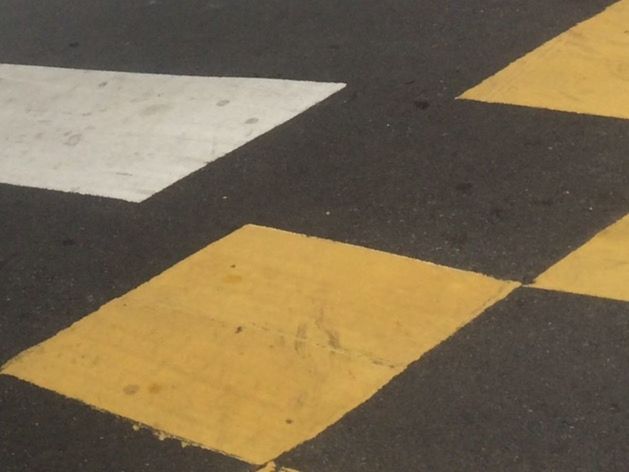 CLOSE-UP OF YELLOW LINES ON THE ROAD