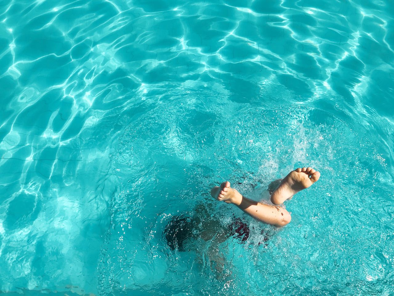 High angle view of boy swimming in pool