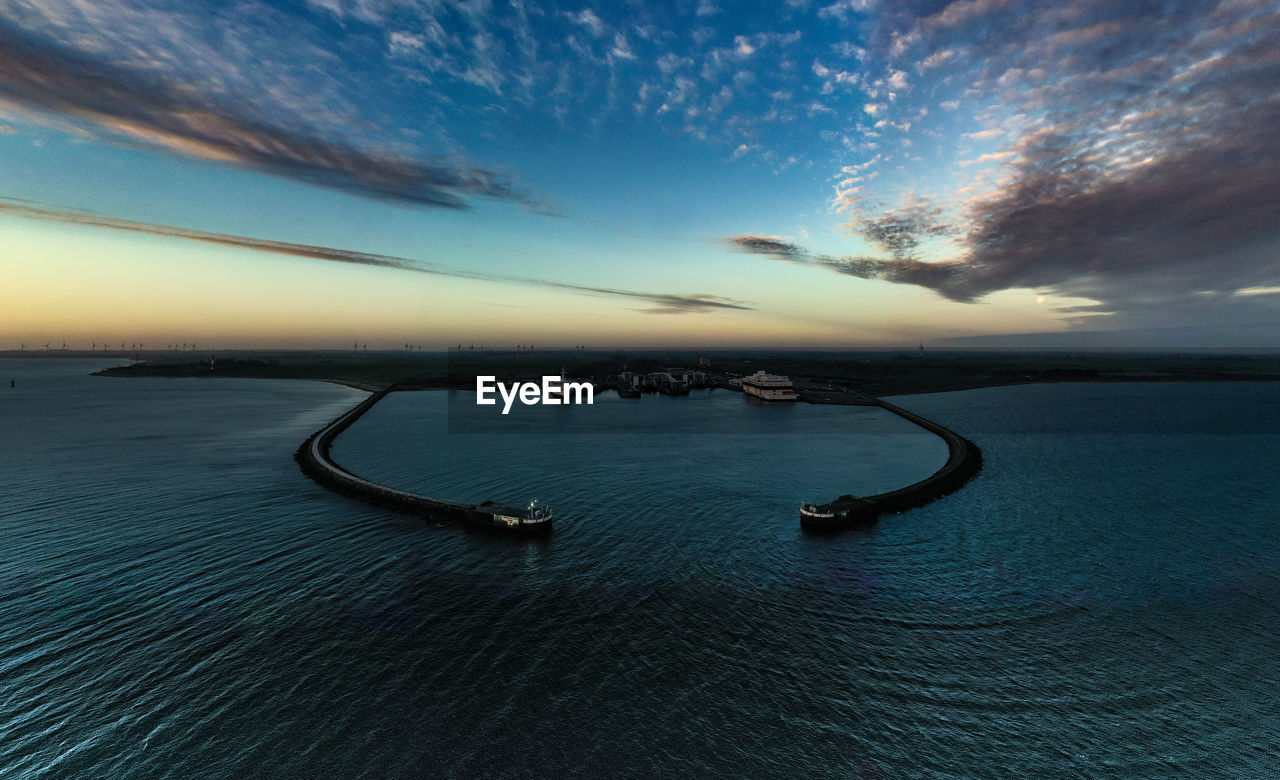 Scenic view of sea against sky at sunset