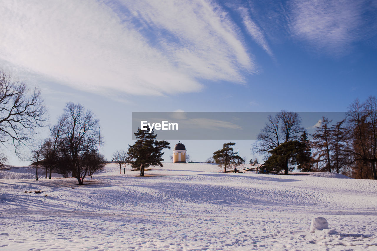 Snow covered field against sky