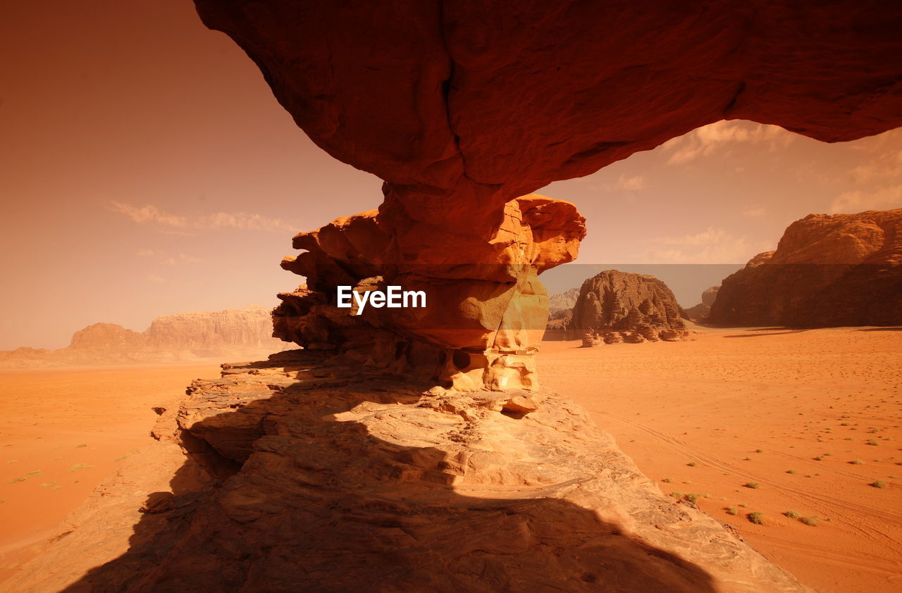 Rock formation in desert against sky