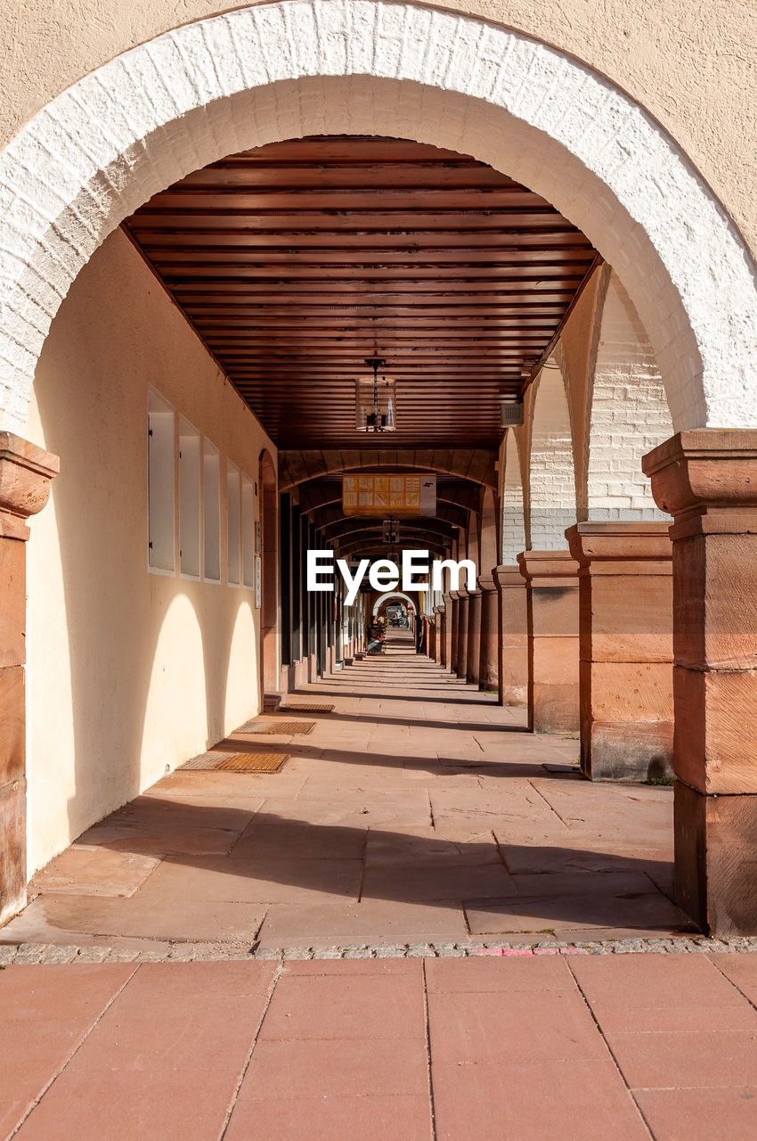 EMPTY CORRIDOR OF BUILDING WITH COLONNADE