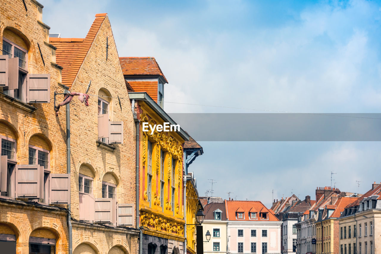 Houses in city against sky