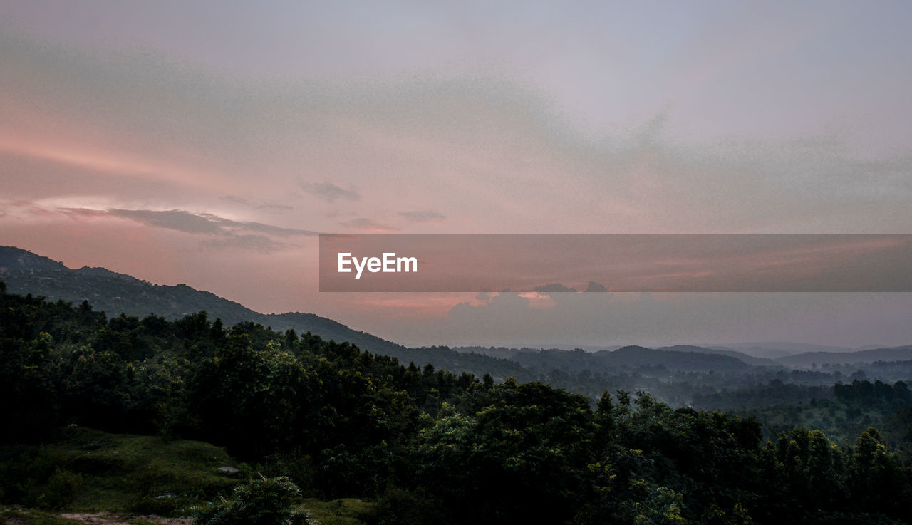 Scenic view of mountains against sky at sunset