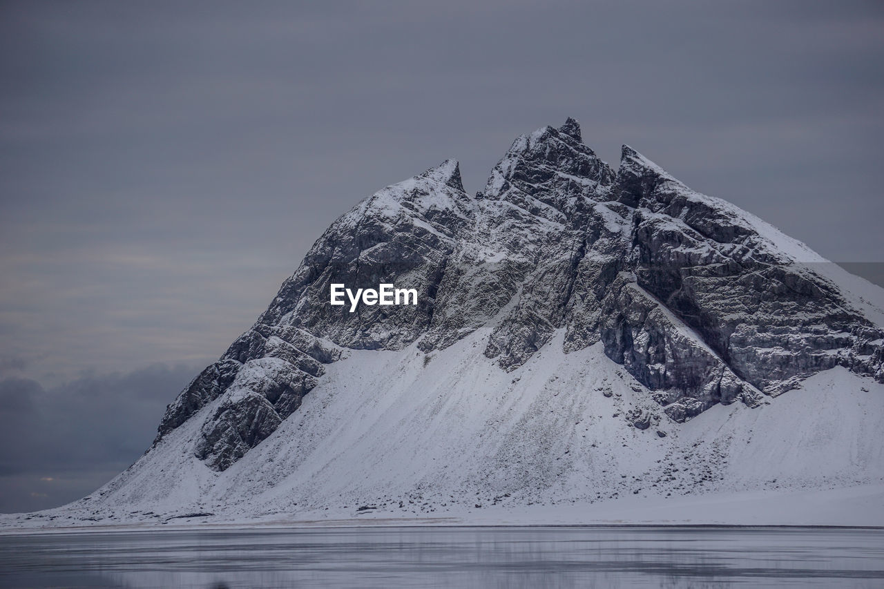 Snow on mountain against sky during winter