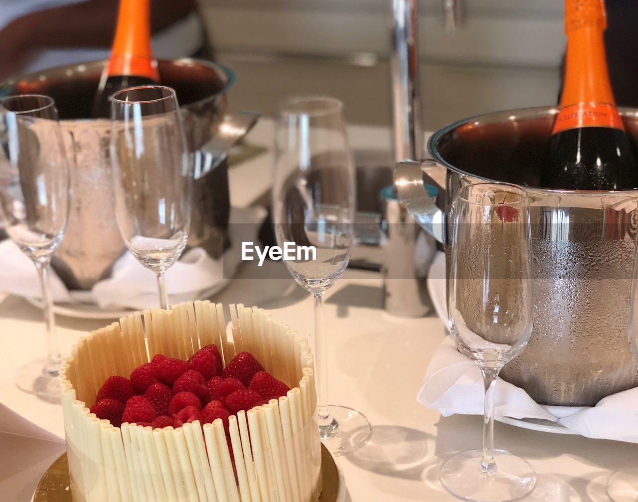 Close-up of champagne with raspberries on table