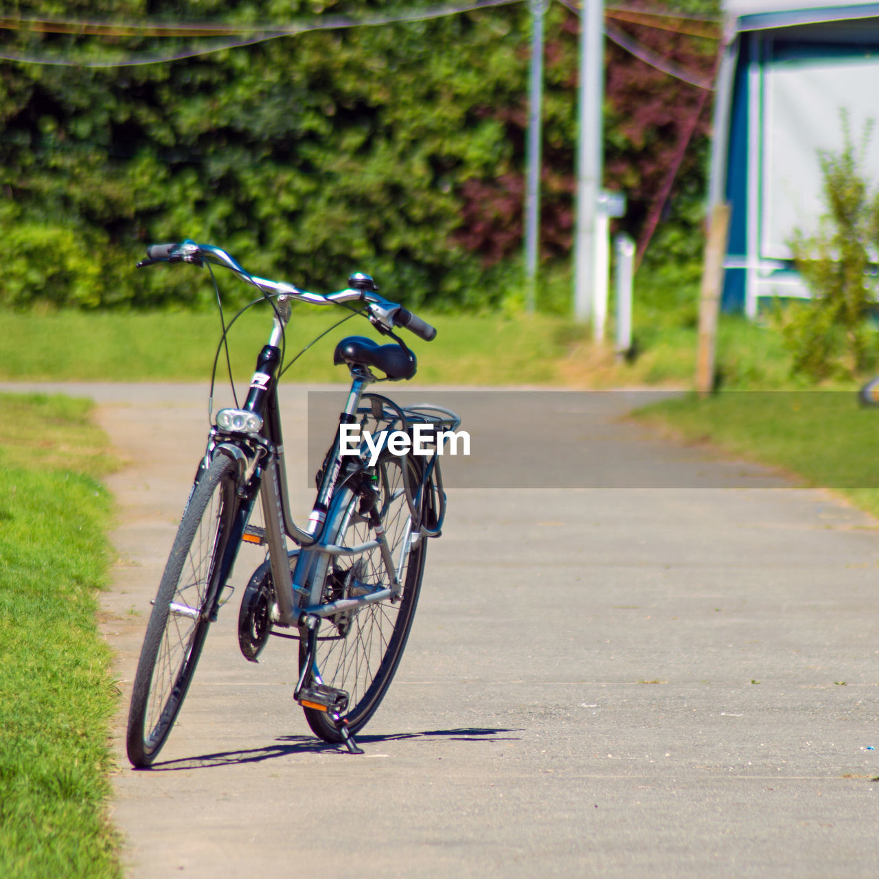 Bicycle parked on empty paved footpath