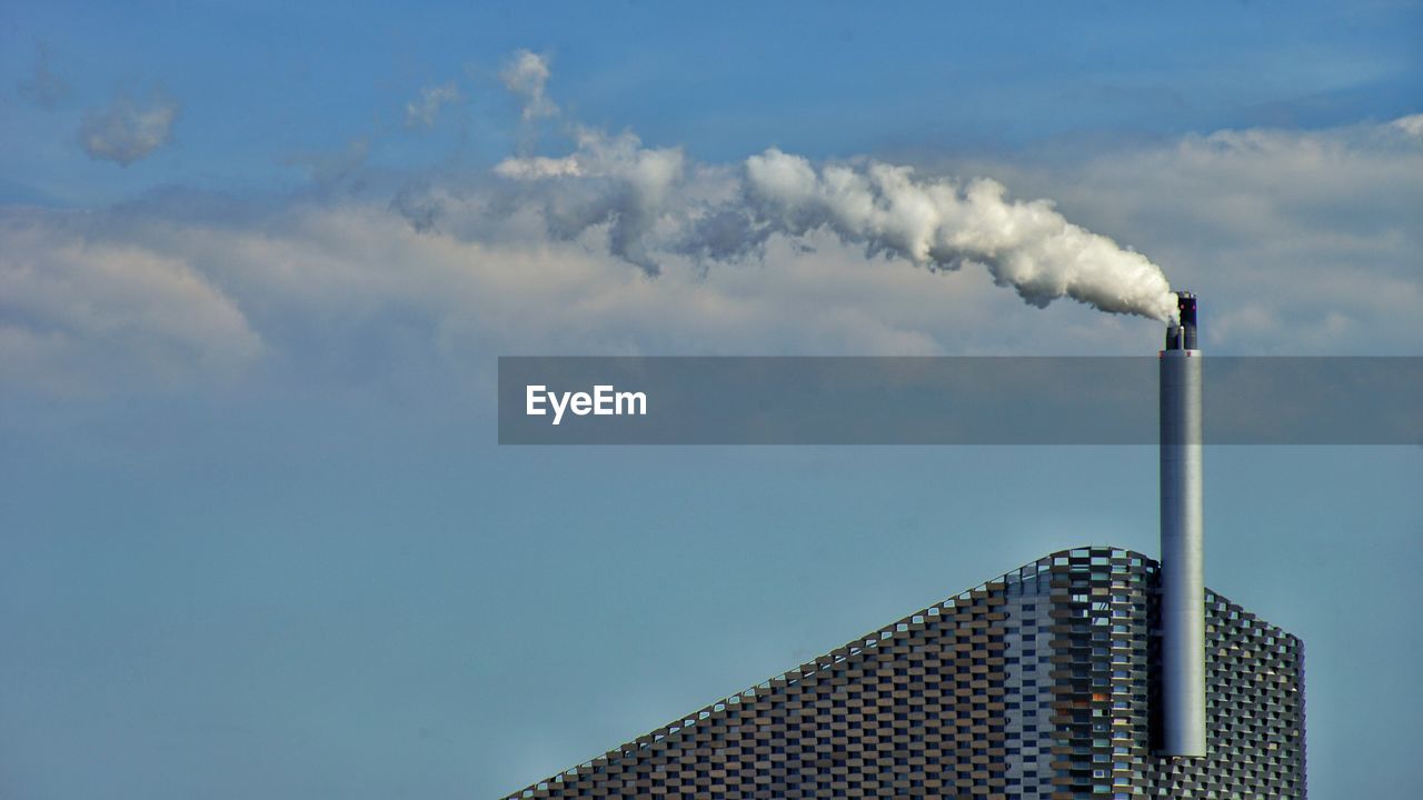 SMOKE EMITTING FROM CHIMNEY AGAINST SKY