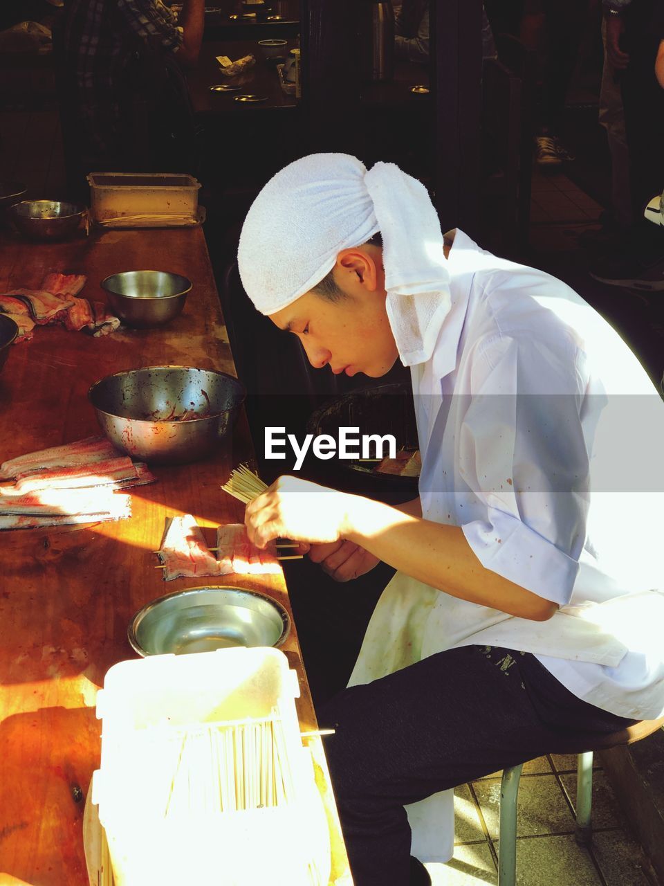 Side view of chef preparing food on table 