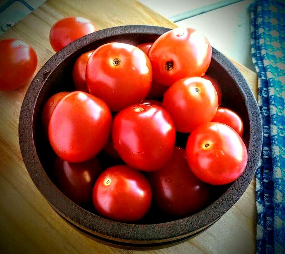 FULL FRAME SHOT OF TOMATOES ON RED BACKGROUND