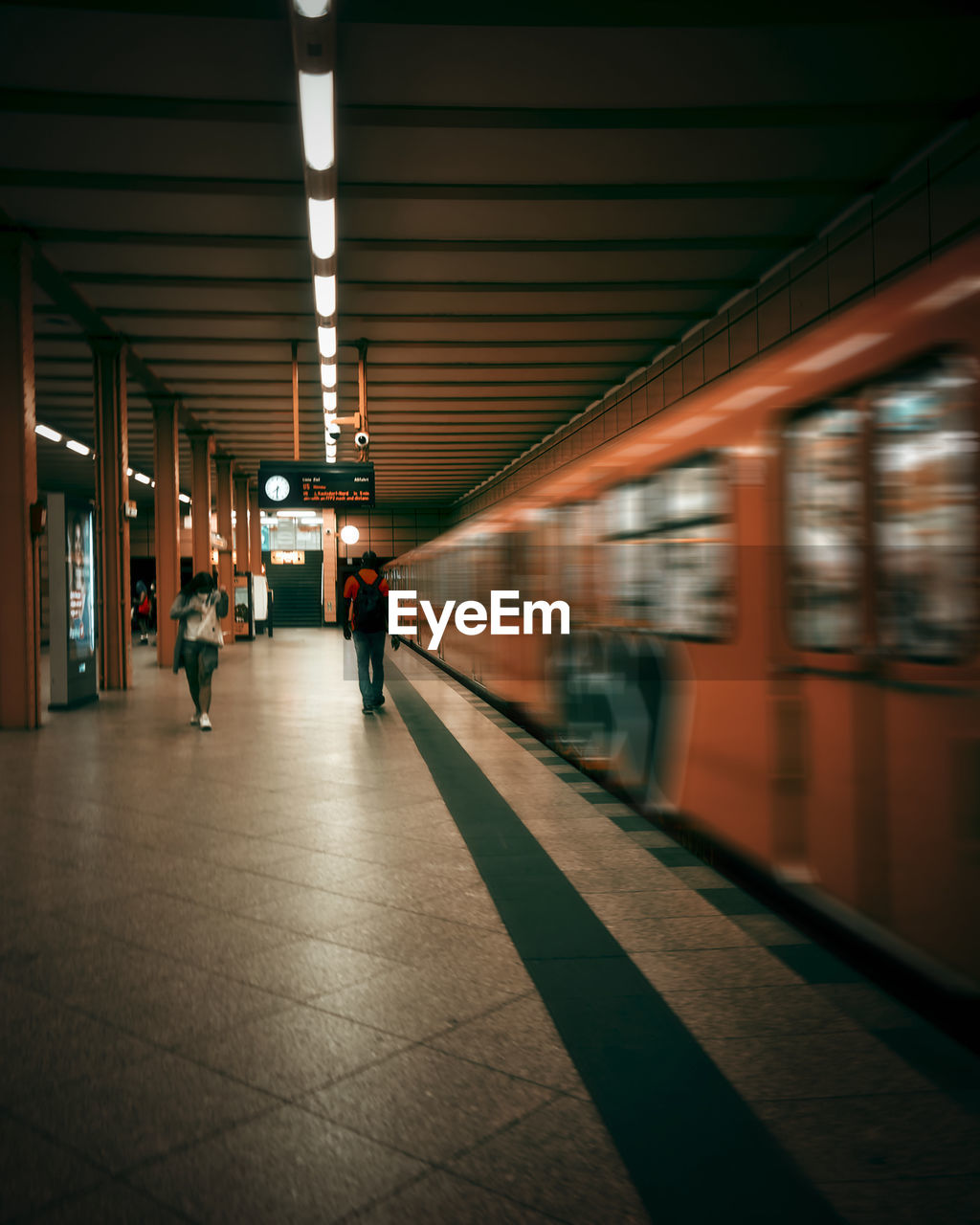 Rear view of woman walking in subway