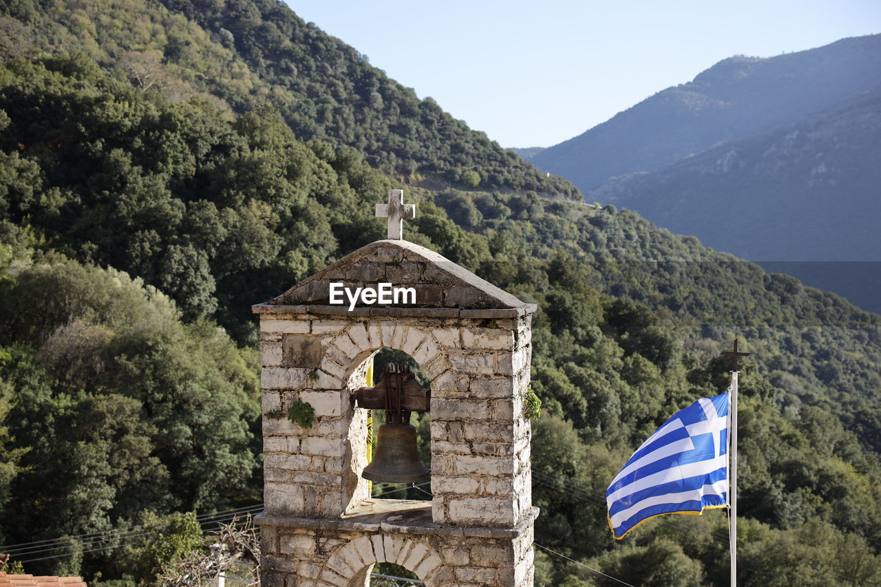 View of bell tower and mountain against sky