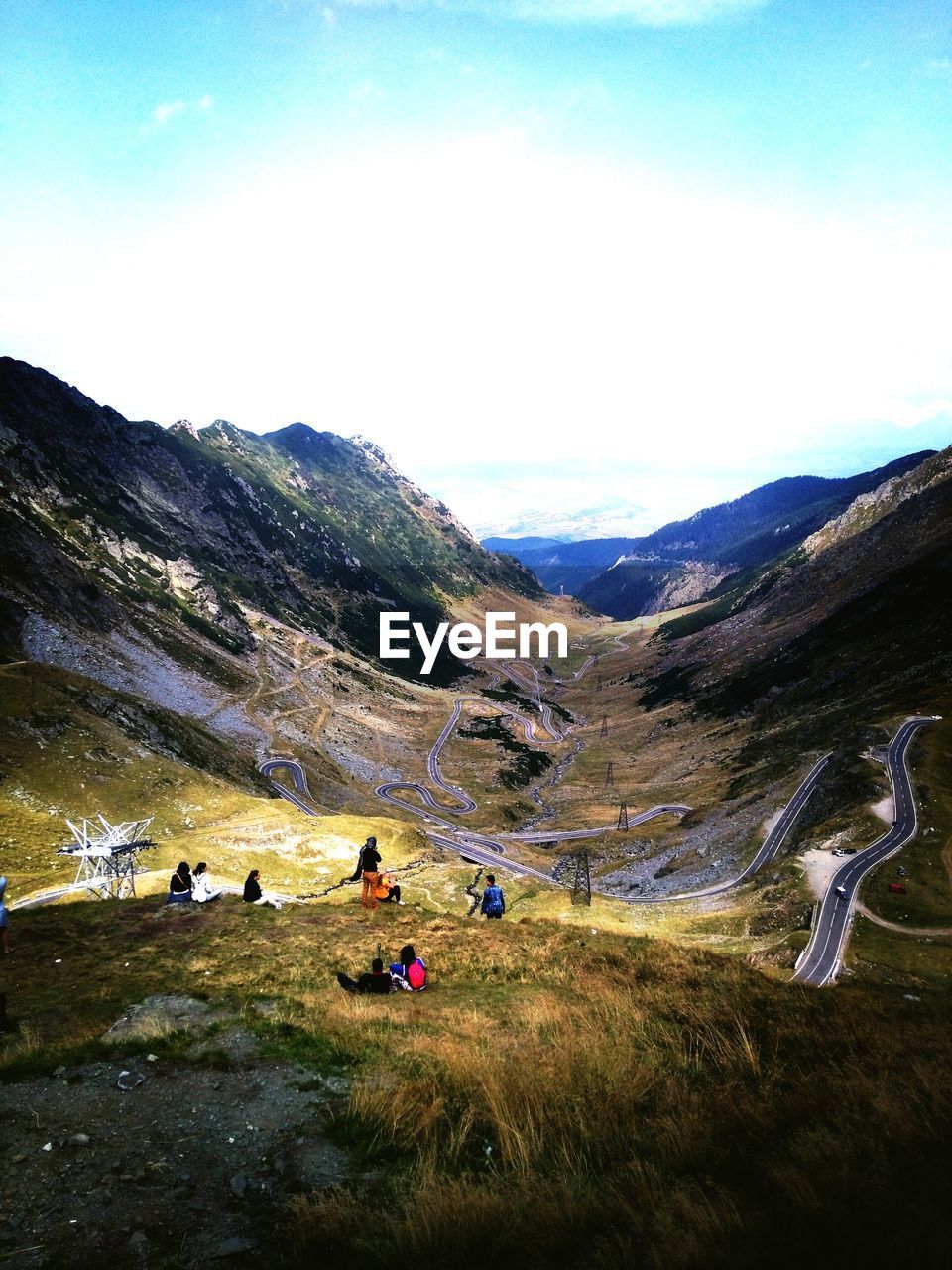 People on mountain against sky