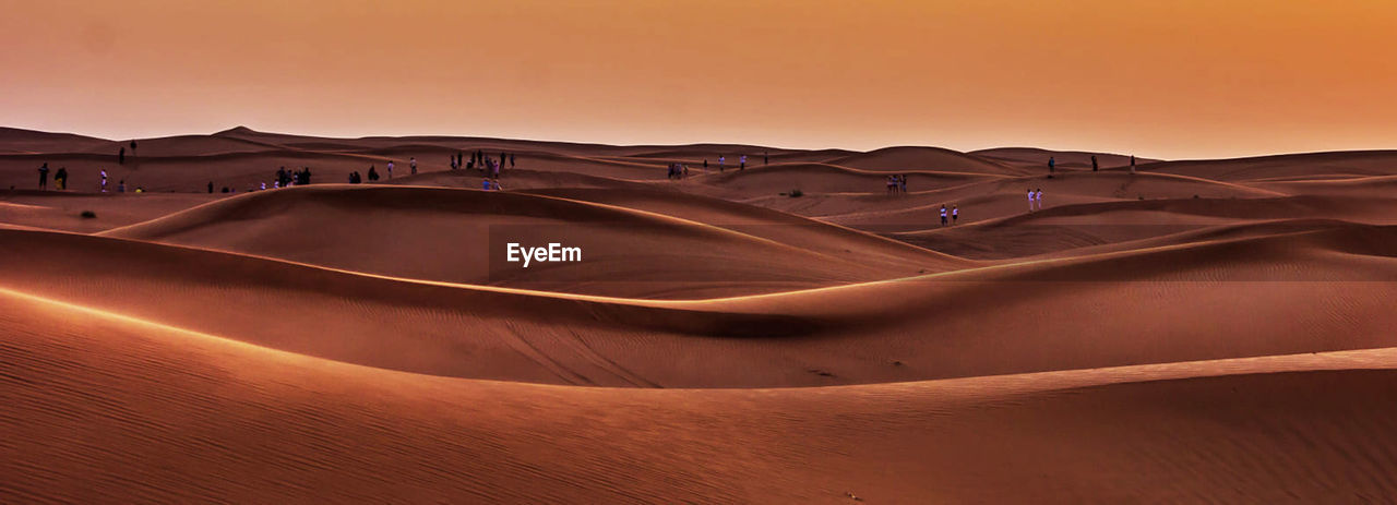 Scenic view of desert against sky during sunset