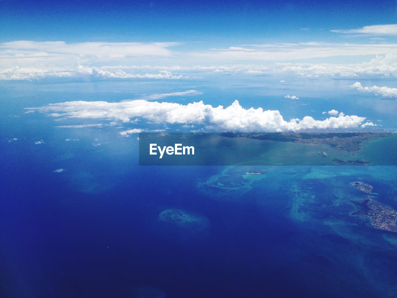 High angle shot of clouds at calm blue sea