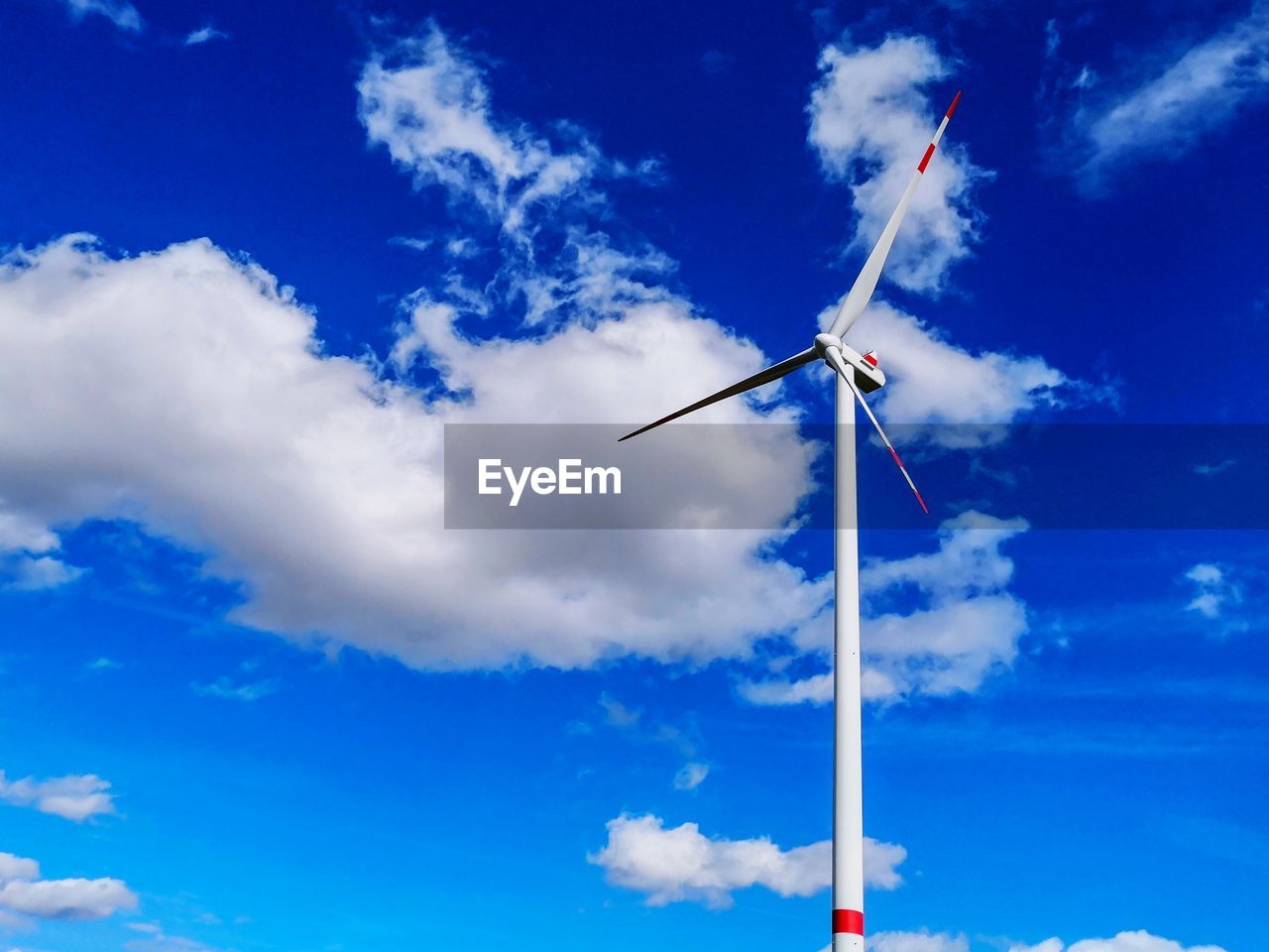 LOW ANGLE VIEW OF WINDMILLS AGAINST SKY