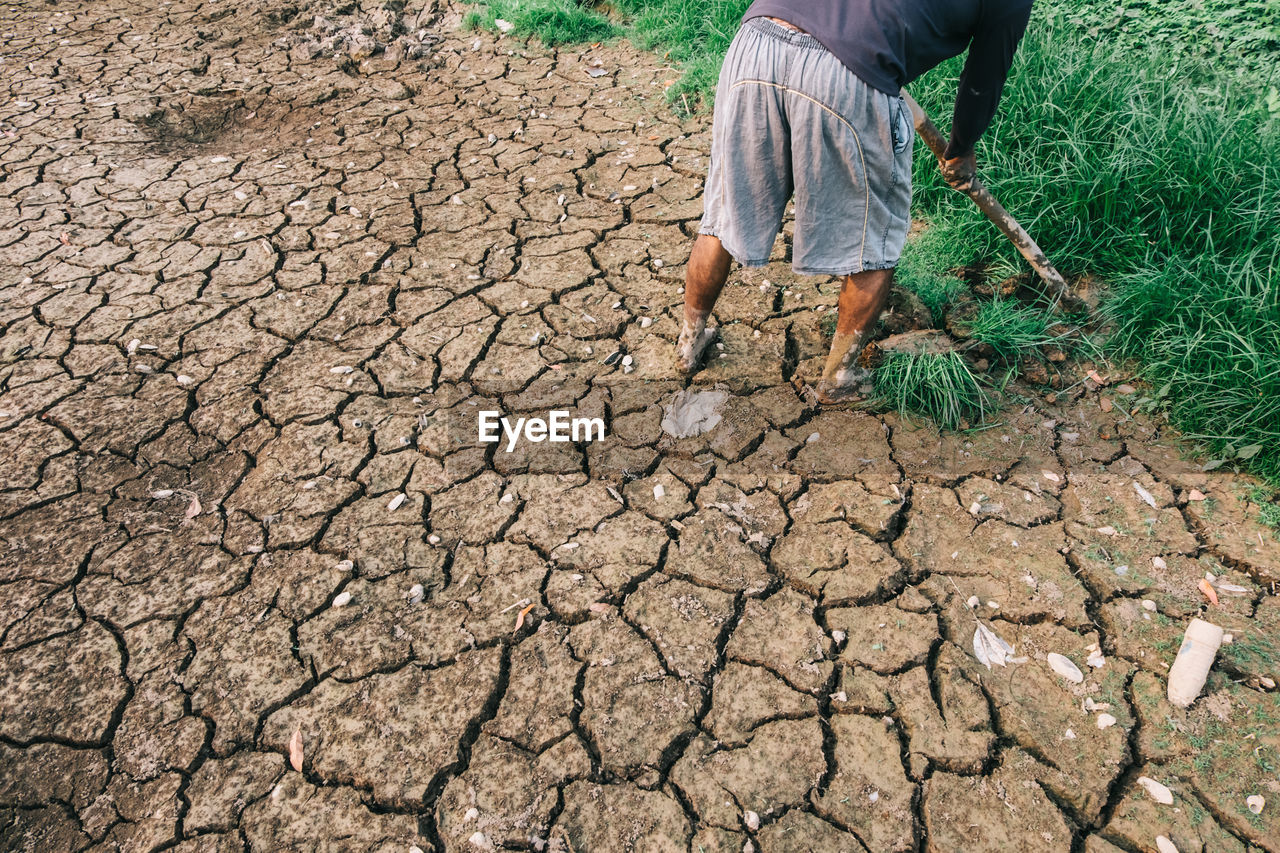 Low section of man working in mud