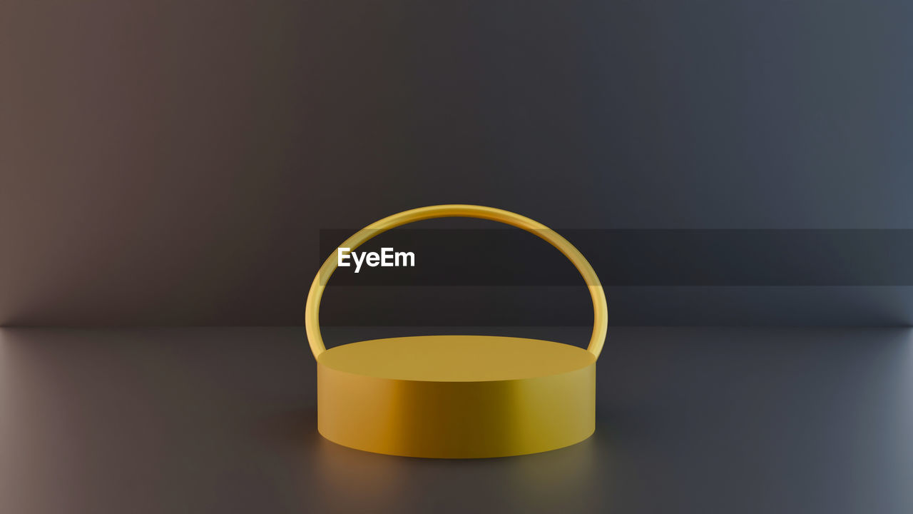 CLOSE-UP OF YELLOW LAMP AGAINST WALL