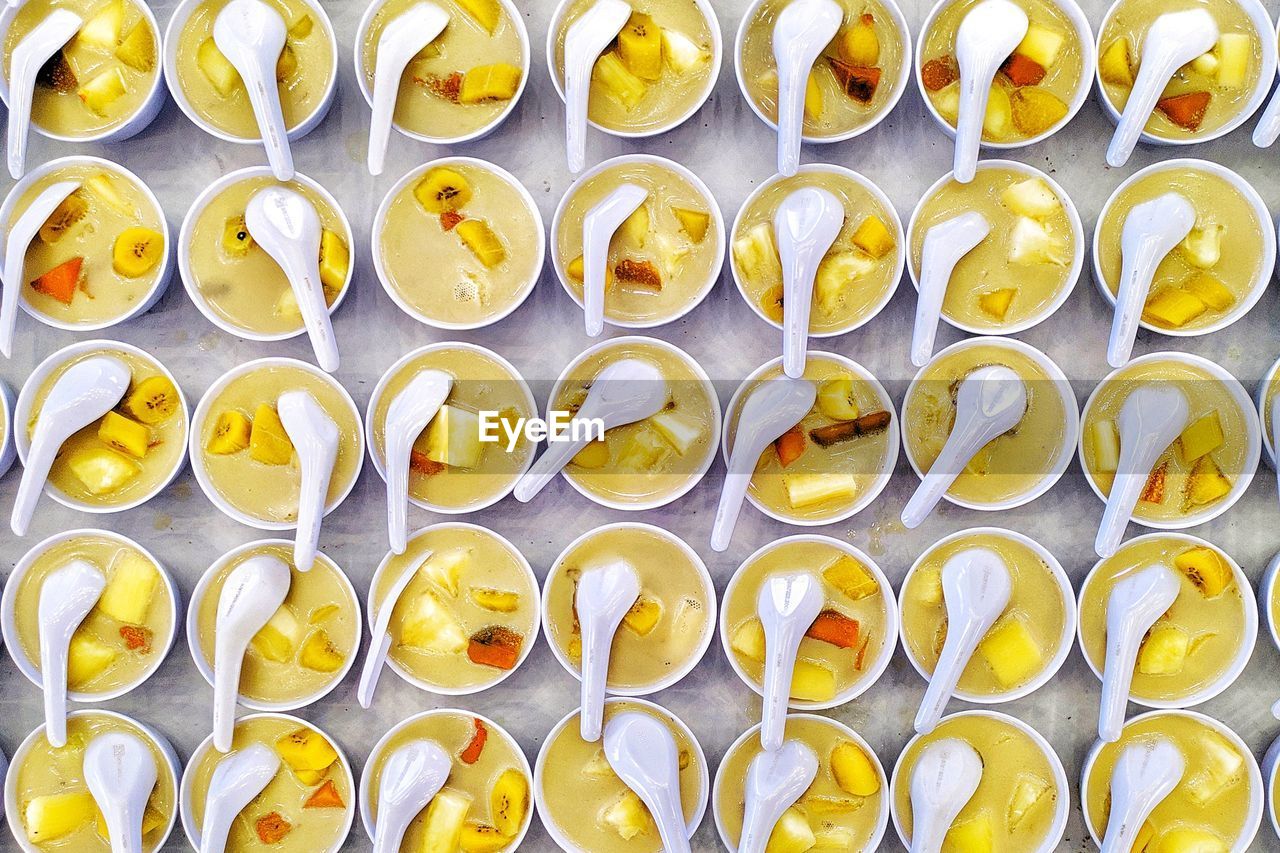 FULL FRAME SHOT OF YELLOW GLASS WITH CANDIES