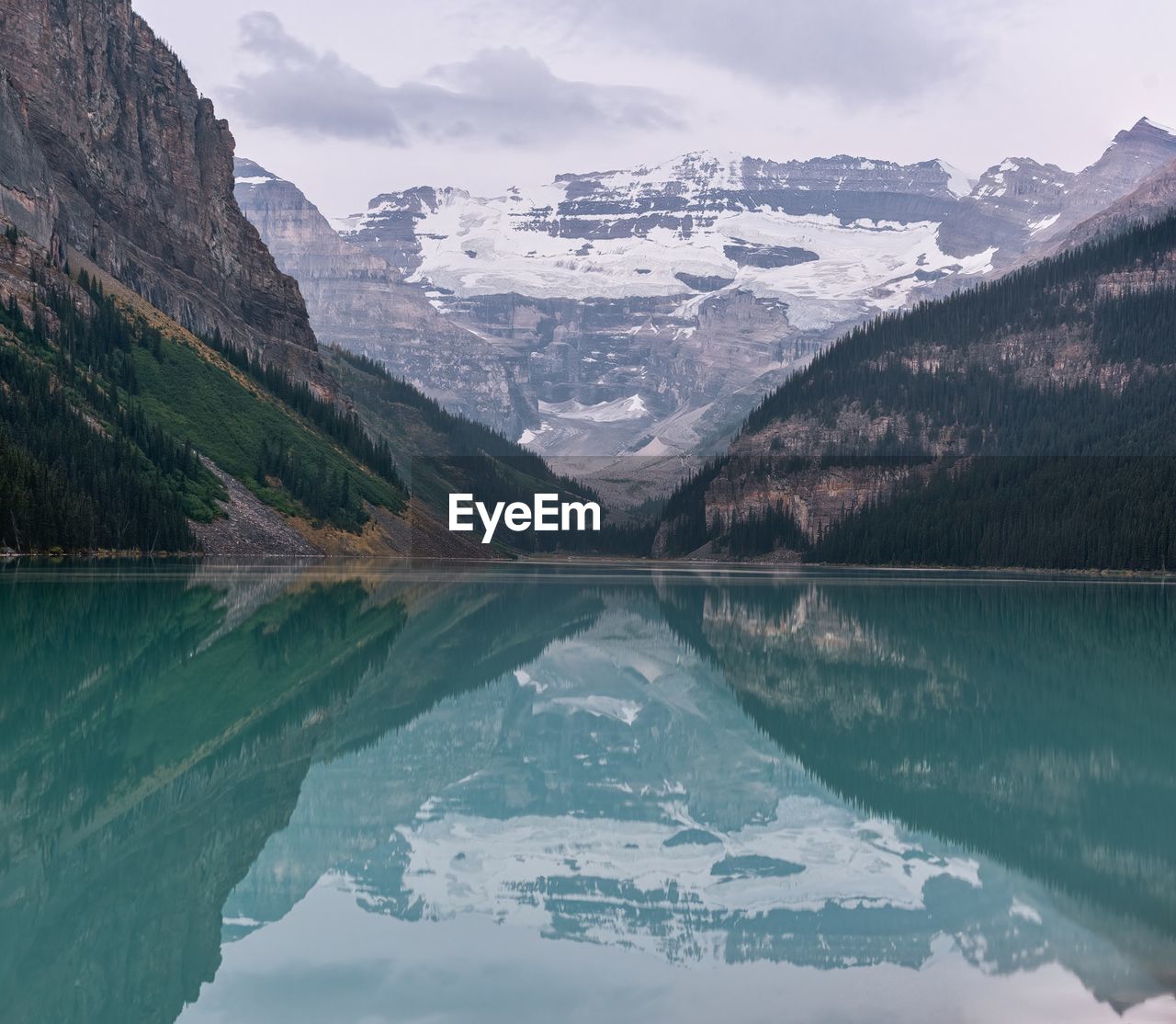 Scenic view of lake and snowcapped mountains against sky