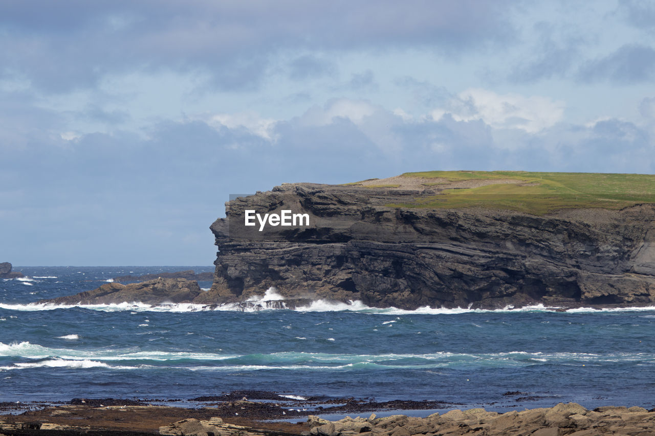 sea, water, land, beach, ocean, shore, sky, coast, body of water, rock, beauty in nature, scenics - nature, nature, cloud, wave, cliff, horizon, coastline, no people, environment, terrain, wind wave, bay, cove, day, outdoors, travel destinations, tranquility, motion, tranquil scene, non-urban scene, rock formation, landscape, travel, tourism