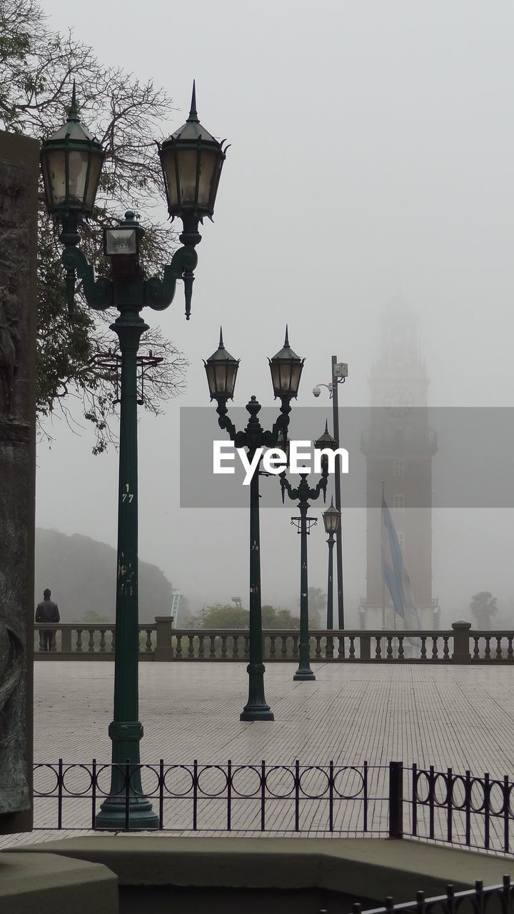 Lamp posts on footpath at plaza san martin during foggy weather
