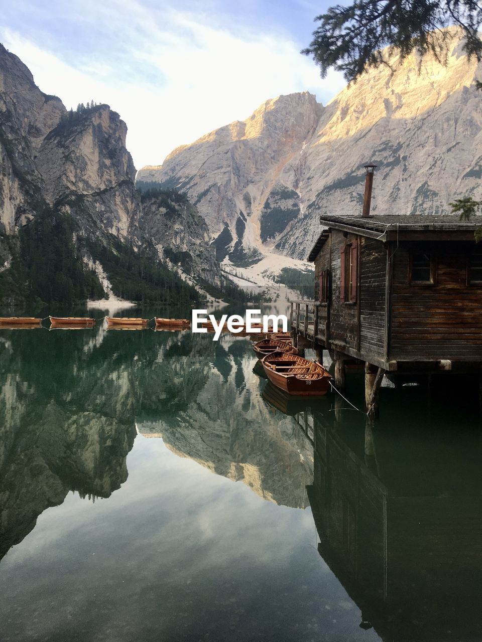 scenic view of lake by mountains against sky