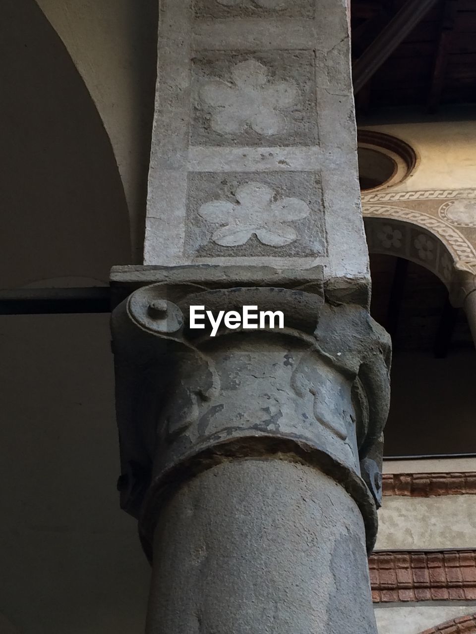 Low angle view of column with floral pattern at saint marta cloister