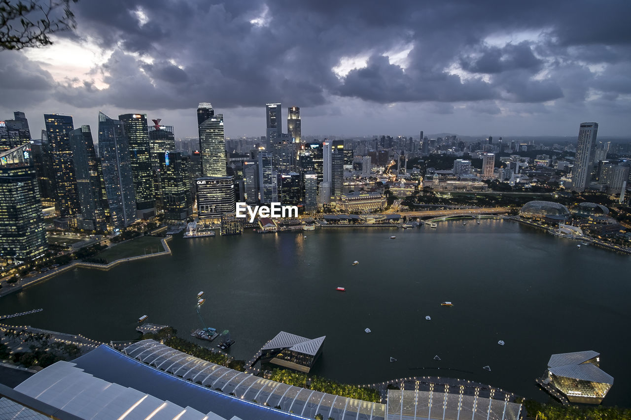 High angle view of river amidst buildings in city against sky