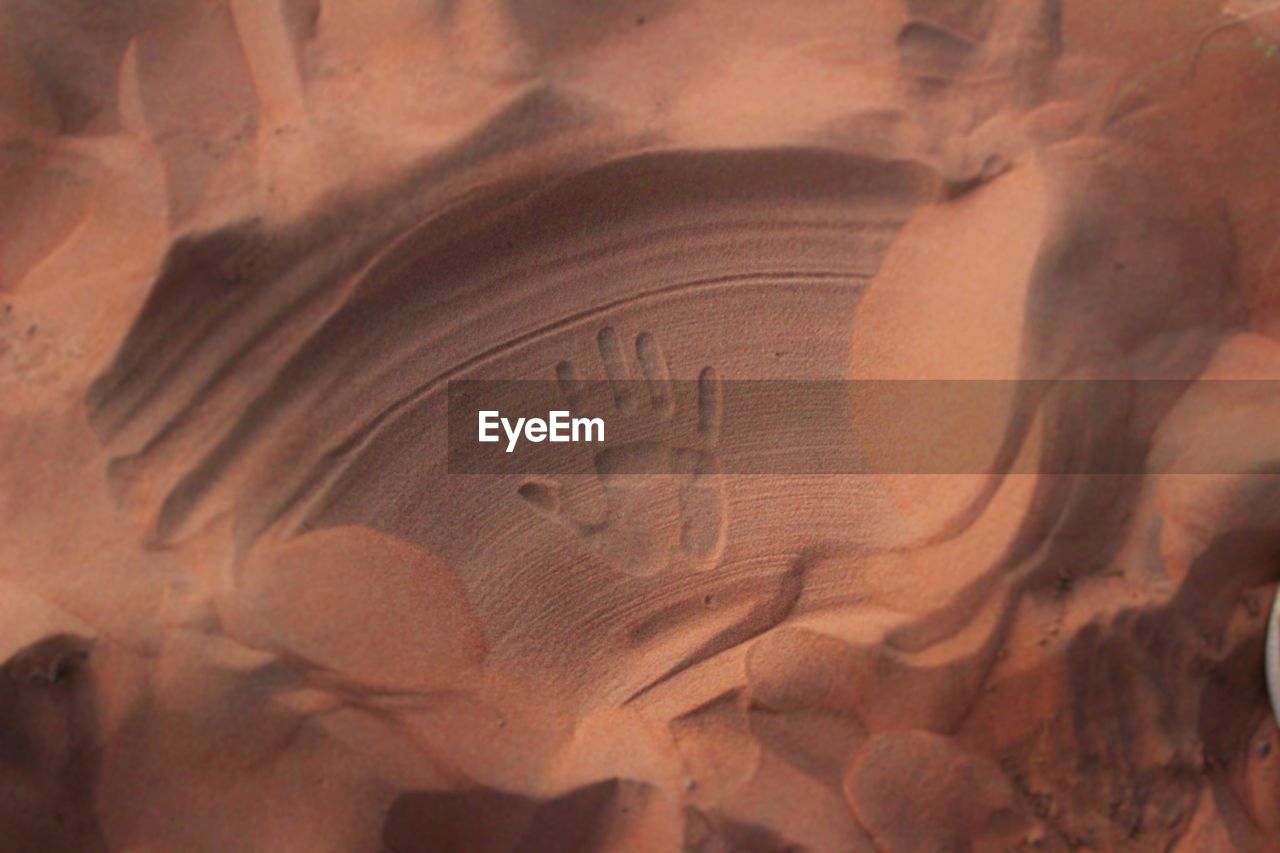 High angle view of handprint on sand