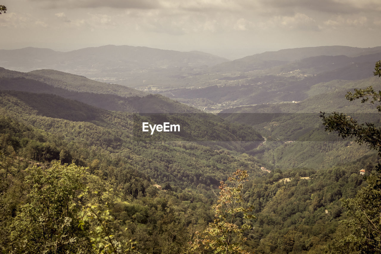 High angle view of valley and mountains against sky