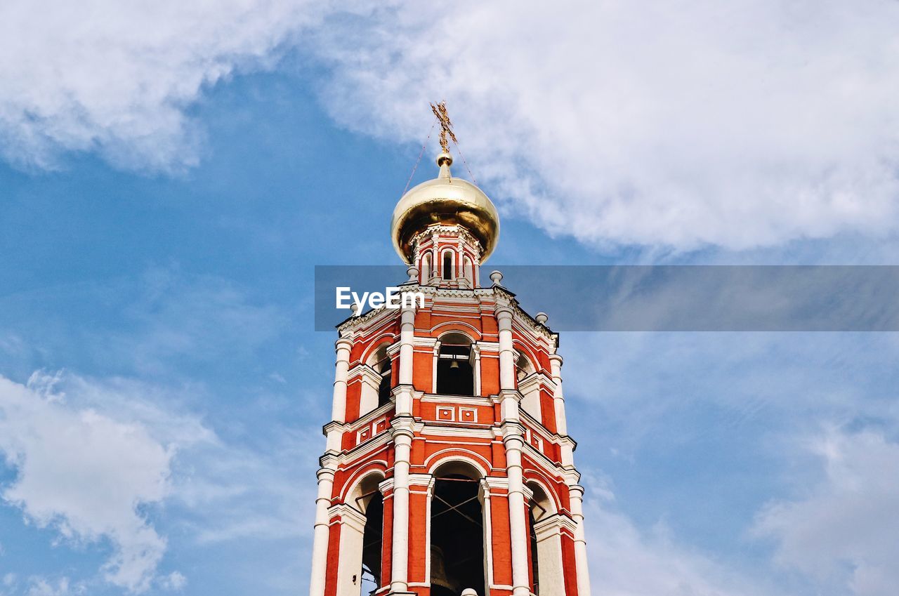 Low angle view of church against cloudy sky