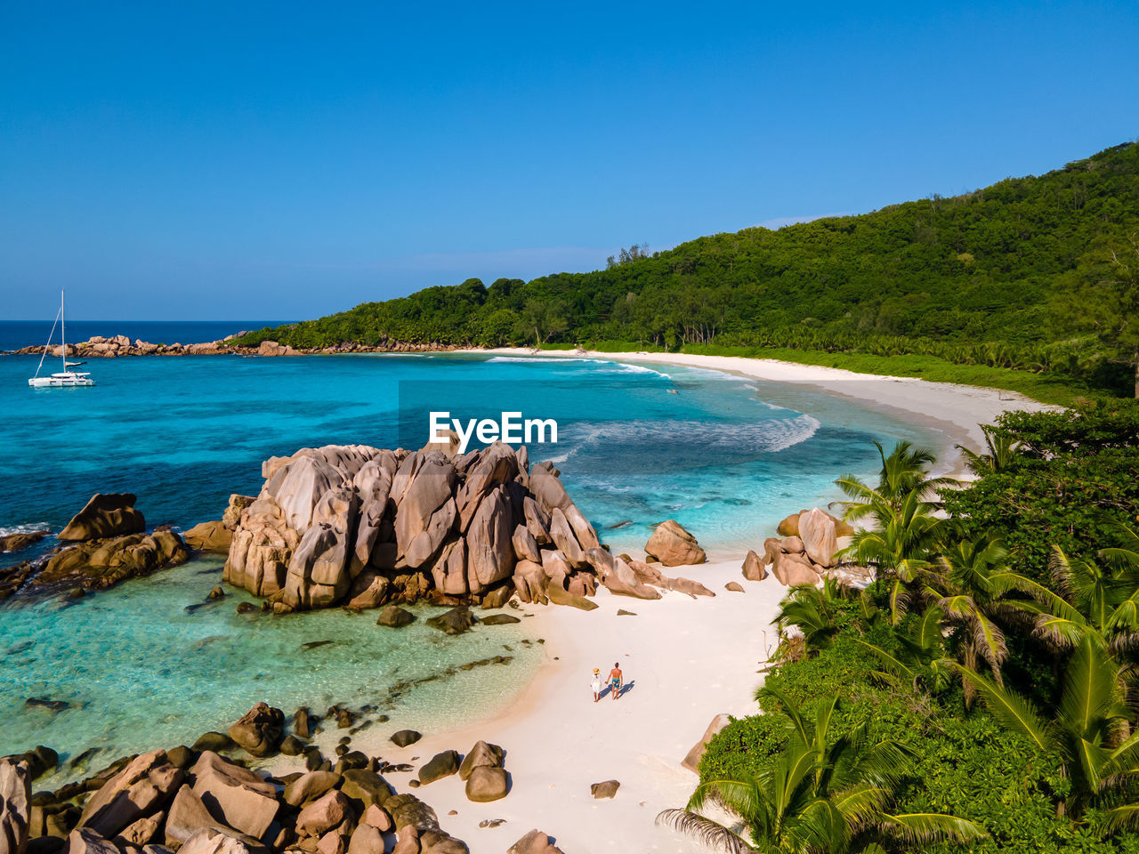 scenic view of beach against clear blue sky