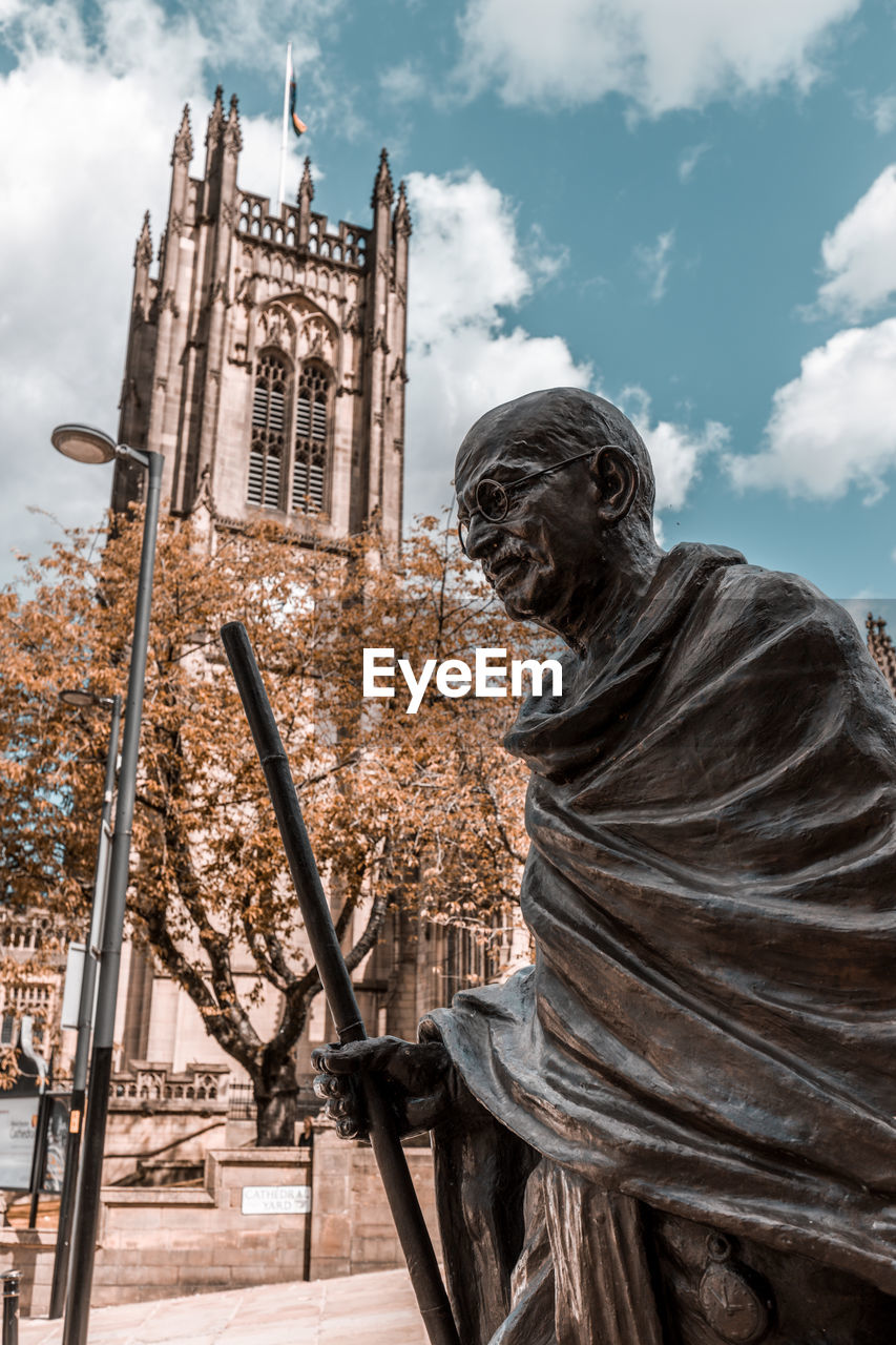 Ghandi statue in front of manchester cathedral pov