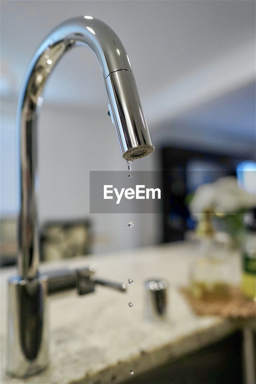 Close-up of water from faucet in kitchen 