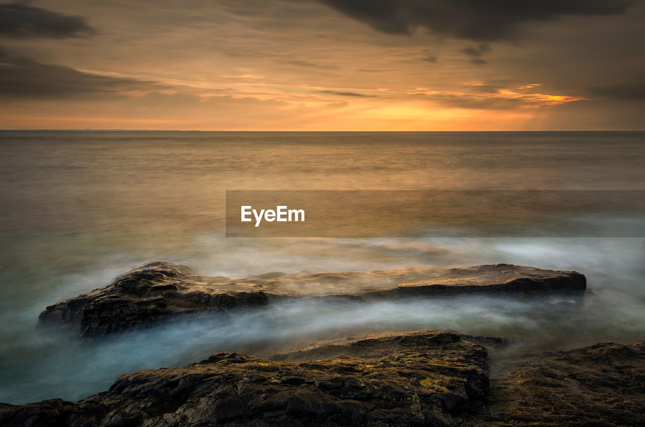 Scenic view of sea against sky during sunset