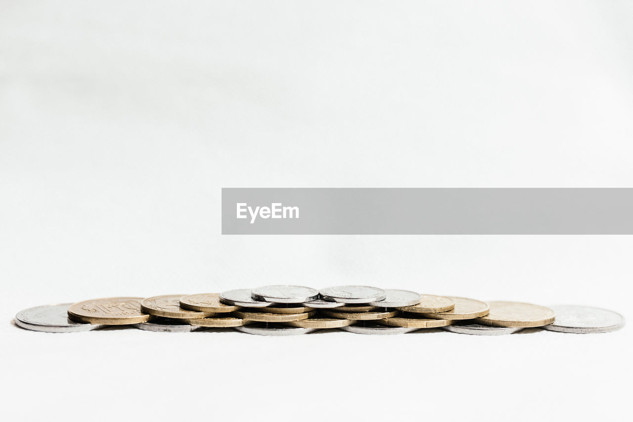 Close-up of coins on white background